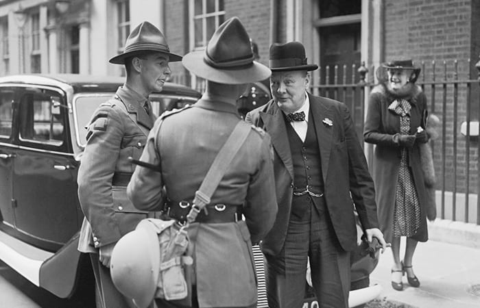 Winston churchill shaking hands with british soldiers