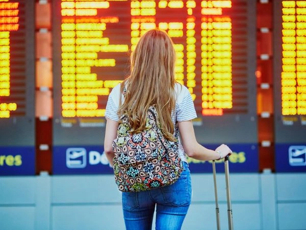 student at an airport ready to fly abroad
