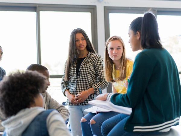 kids in classroom listening to their english language teacher