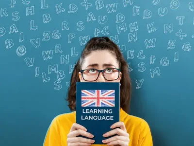 school student holding up an english language dictionary